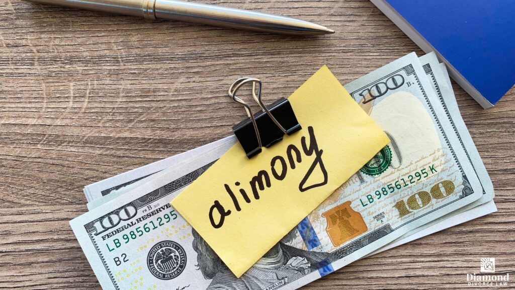 A stack of money held together with a binder clip and a sticky note that says "alimony".