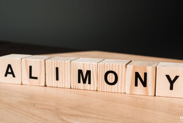 Wooden blocks on a table spelling out the word "alimony".