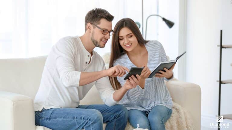 A young couple discussing finances while sitting on a couch.