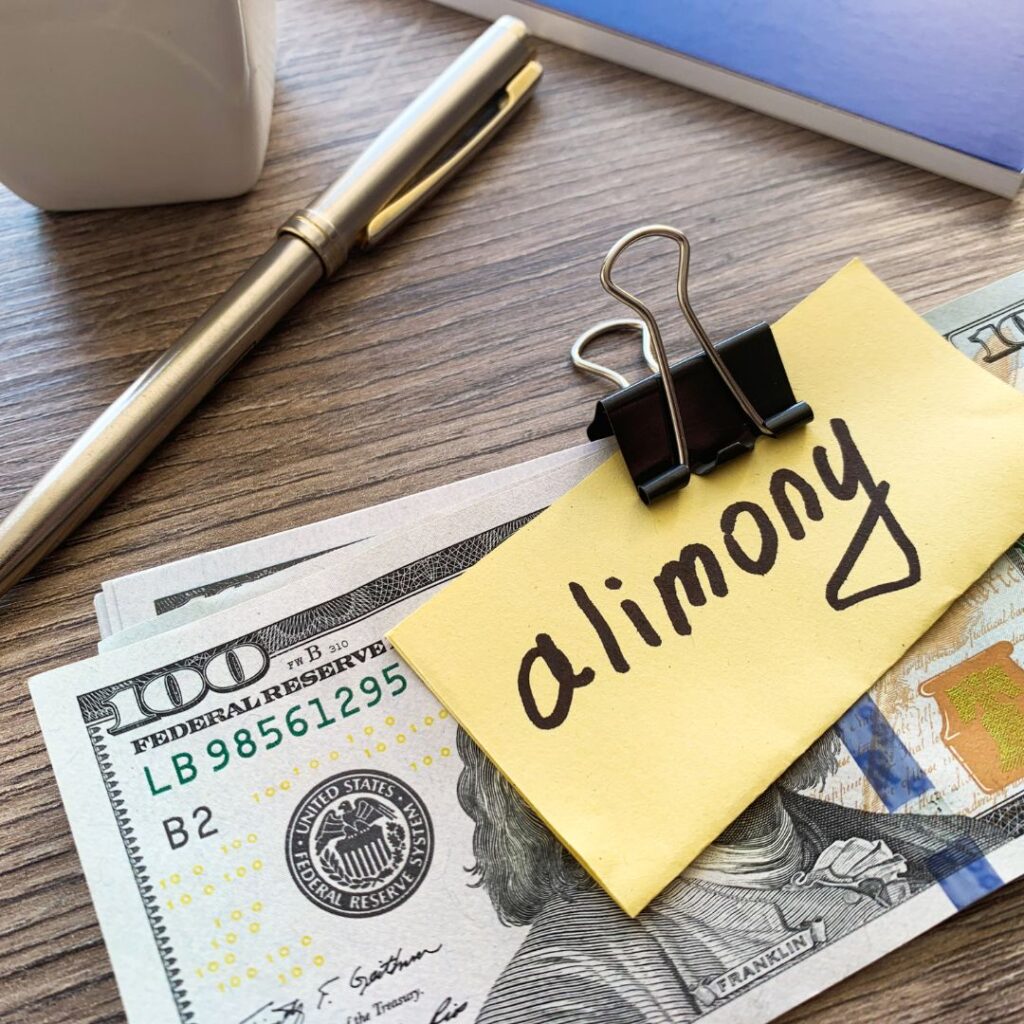 A stack of 0 bills clipped together with a note that says "alimony".