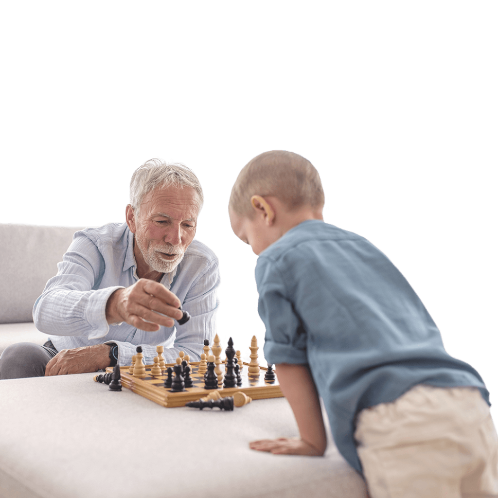 A grandfather and his grandson playing chess.